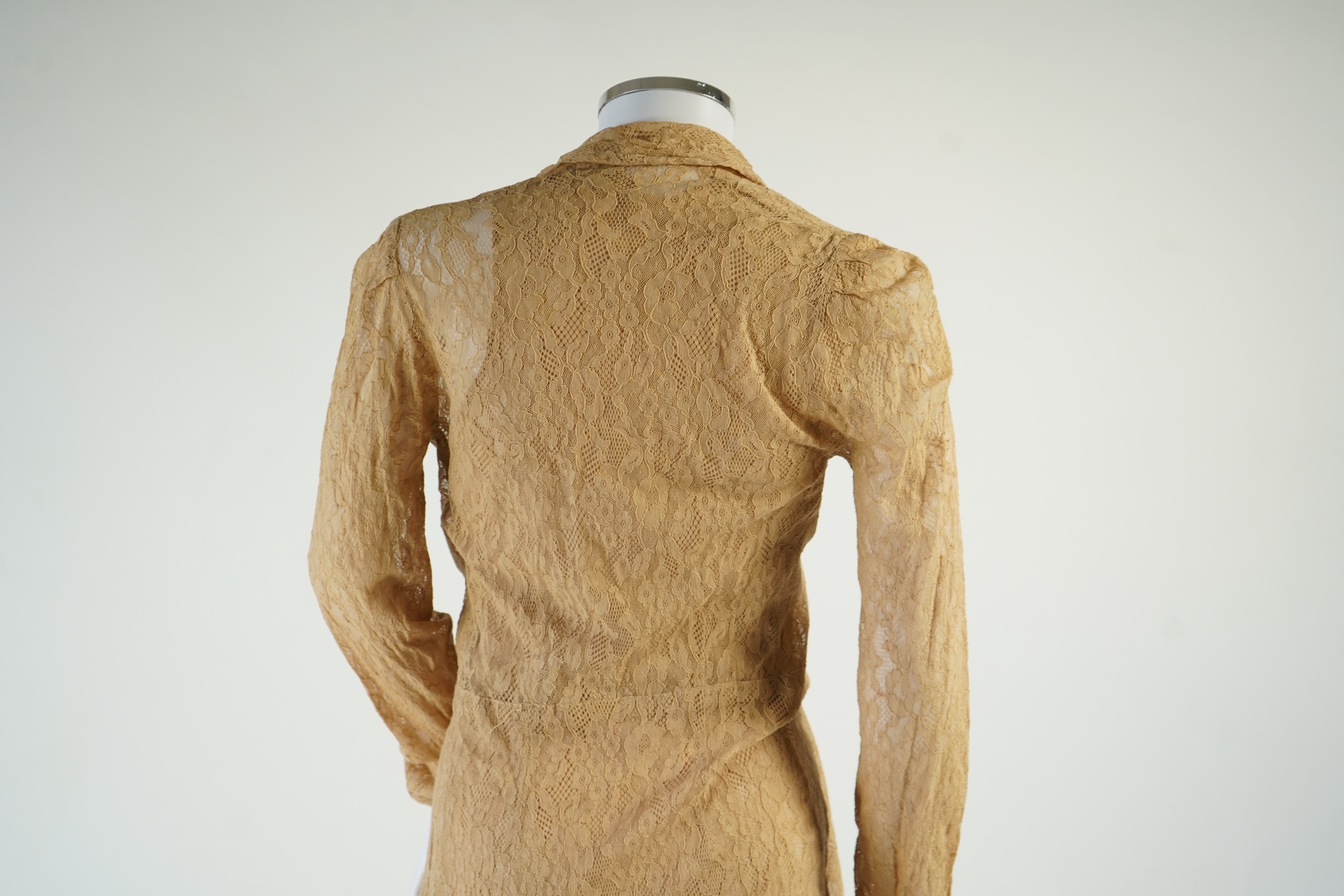 A flesh coloured 1930s lace evening dress and matching jacket together with a bottle green velvet evening dress and buckle belt and an unusual green shot silk pleated under skirt. Lace dress bust 32 inches. 156cm long. C